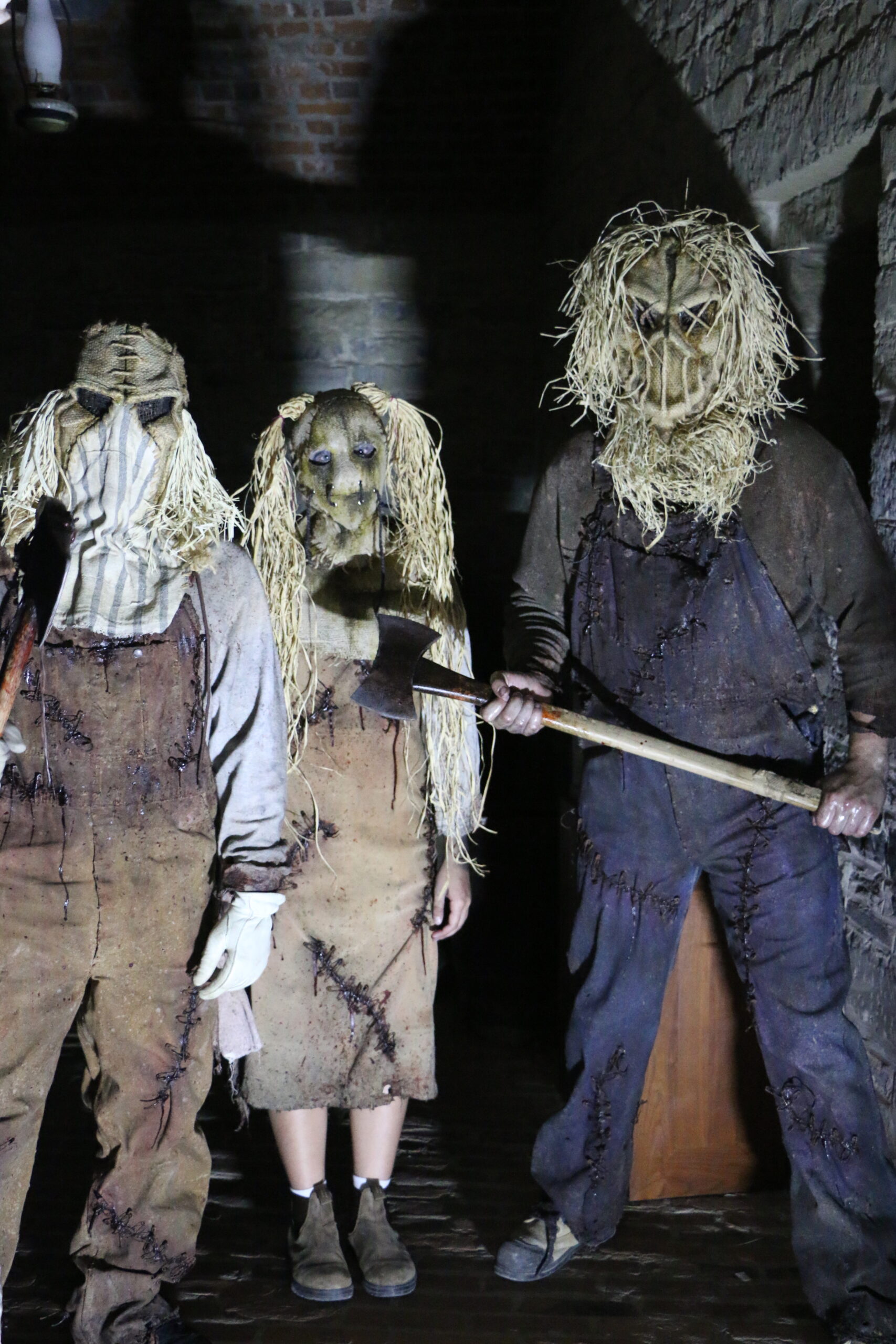 Actors in spooky costumes interacting with guests during Fort Fright